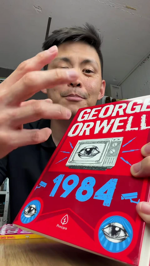 Capa vermelha de 1984 com uma televisão e um olho